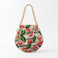 Beige floral potli bag held in hand