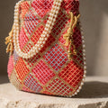 Orange mirror work potli bag with drawstring