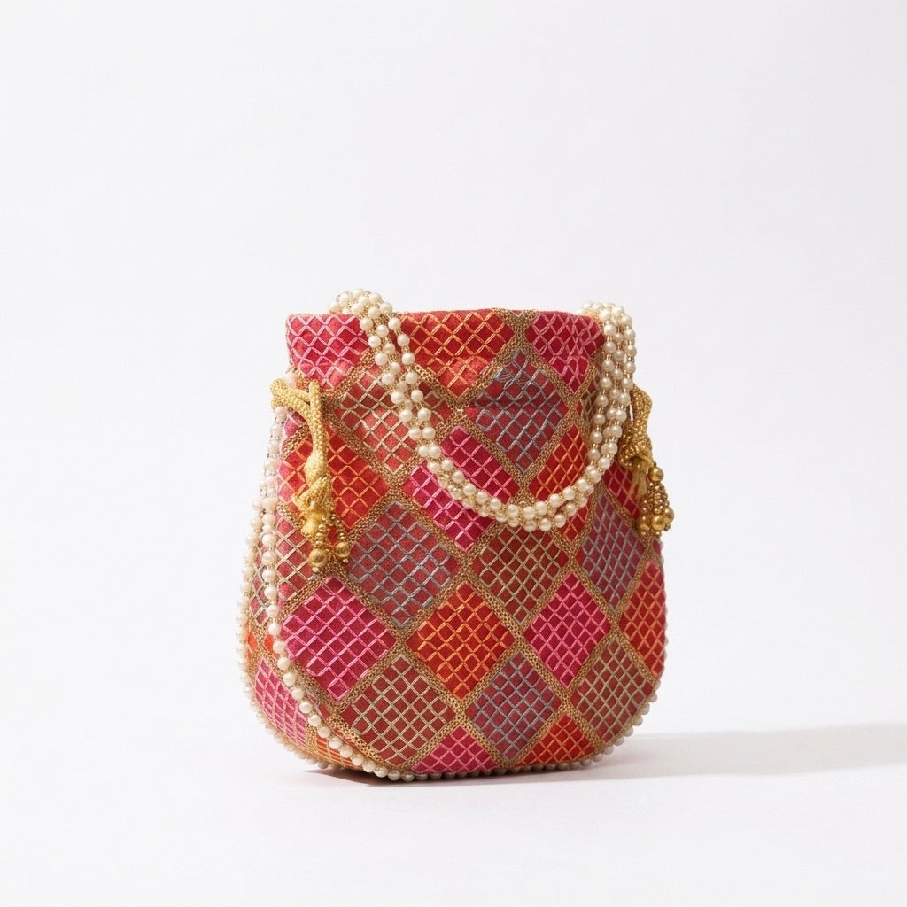Orange mirror work potli bag ethnic accessory