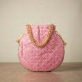 Pink mirror work potli embroidery detail