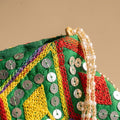 Green mirror work potli embroidery detail
